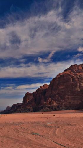 a view of a desert with mountains in the background at Wadirum Zeid camp&Tours in Wadi Rum