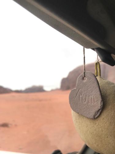 a teddy bear with a heart on the dashboard of a car at Wadirum Zeid camp&Tours in Wadi Rum
