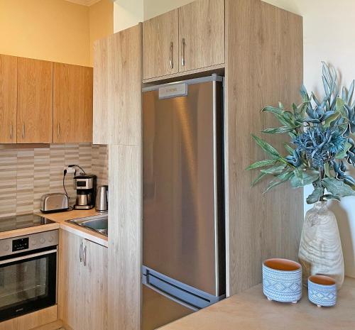 a kitchen with a stainless steel refrigerator at Kimata Sea View Apartment in Argassi