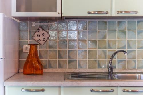 a kitchen with a sink and a vase on the counter at Appartamento Colomba in Capo Testa