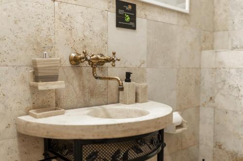 a bathroom with a sink in a room at Family Villa Tiffany&more in Barić Draga
