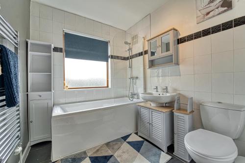 a white bathroom with a sink and a toilet at Guest Homes - Severn Swans House in Worcester
