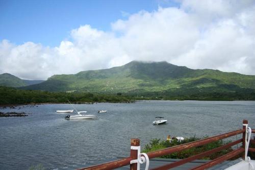 a view of a lake with boats in the water at 21LG Ilot Fortier M Sea Front and Swimming pool in Rivière Noire