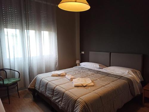 a bedroom with a bed with towels on it at Albergo Italia di Nardi Renzo & C Snc in Poggibonsi