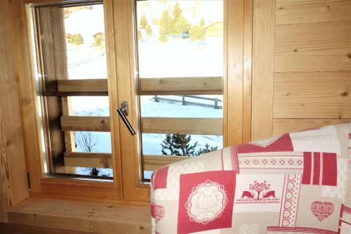 a sliding glass door with a view of a snow covered yard at Chalet des Alpes NATURE & MOUNTAIN by Alpvision Résidences in Prarion