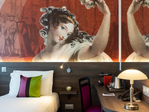a room with a bed and a painting of a woman at Hôtel Roi Soleil Prestige Plaisir in Plaisir