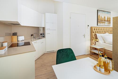 a kitchen and a living room with a table and chairs at Mühlensteg Apartments by VISIMO - Elegant, Quiet, Central in St. Gallen