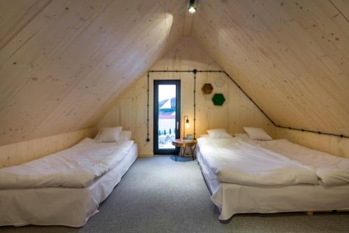 A bed or beds in a room at Domy wypoczynkowe w Beskidach - Odpoczywaj w Naturze