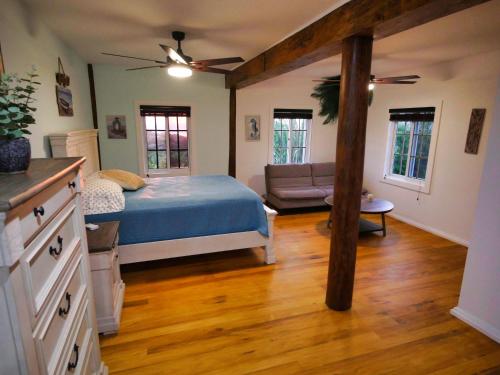 a bedroom with a bed and a couch at Sandy Feet Retreat in Sandy Bay