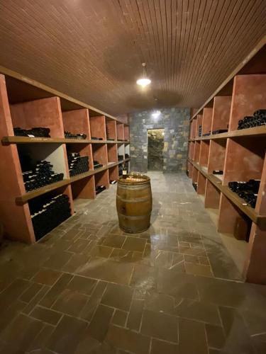 a wine cellar with a barrel in the middle at Farm stay Šibav B&B in Dobrovo
