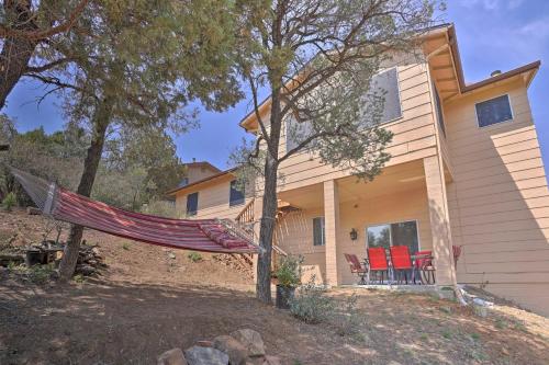 a hammock in front of a house at 5 Mi to Dtwn Prescott Home with Deck and Mtn Views in Prescott