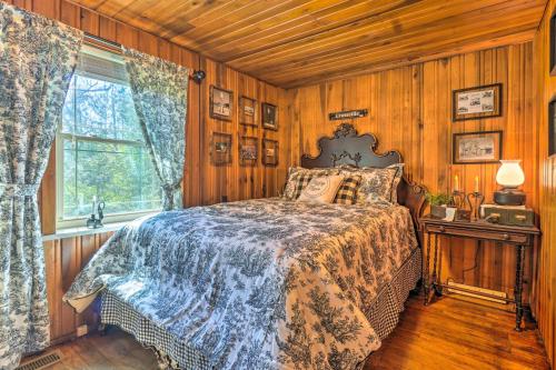 a bedroom with a bed with wooden walls and a window at Dreamy Homestead Escape Patio, Ranch On-Site in Crossville