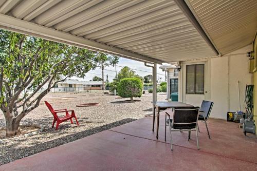 a patio with a table and chairs under awning at 6 Mi to State Farm Stadium WFH-Friendly Home! in Sun City