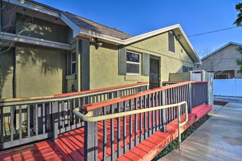 a house with a porch with a fence at Vibrant Dunedin Getaway with Furnished Patio! in Dunedin