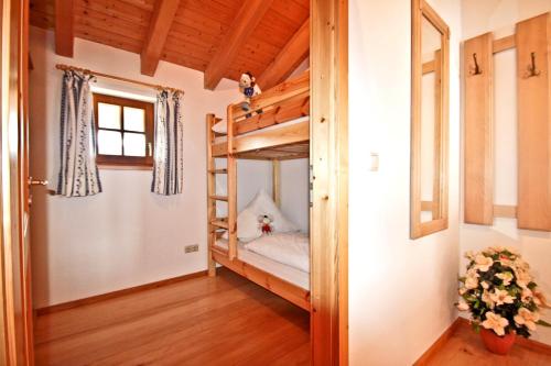 a room with two bunk beds and a window at Ferienwohnungen Wanderparadies Bauernhof in Aschau im Chiemgau
