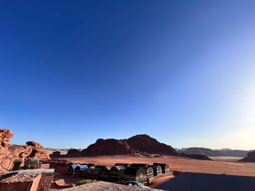 a view of a desert with mountains in the background at Wadirum Zeid camp&Tours in Wadi Rum