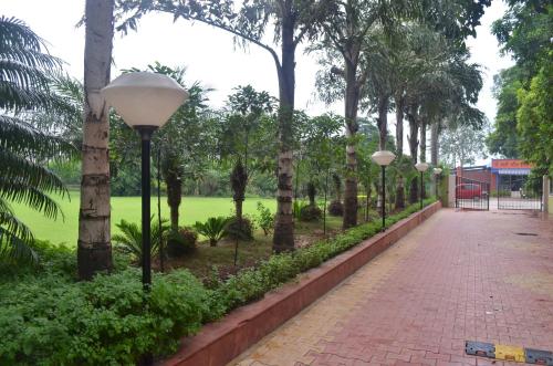 a row of street lights next to a park at The Radha Ashok in Mathura