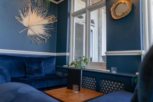 a room with blue walls and a table with a computer at The Wellington Hotel in Ventnor