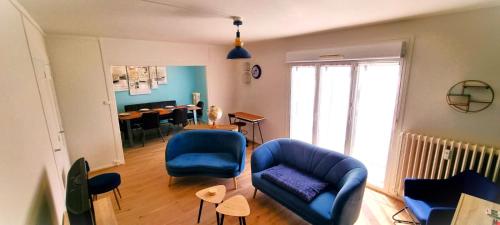 a living room with a blue couch and chairs at Le Douillet par Picardie Homes in Crouy