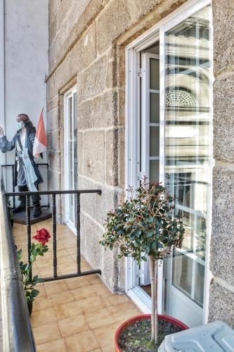 a statue of a man standing on a balcony at Hostal la Colegiata in Vigo