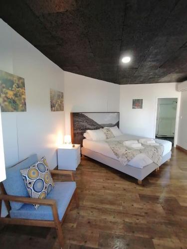 a bedroom with a bed and a couch in it at 44House - Quinta do Casal in Mesão Frio