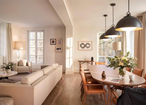 a living room with a couch and a table at Le Grand Pavillon Chantilly in Chantilly