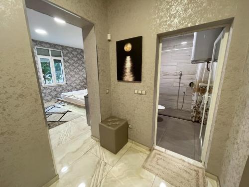 a bathroom with a walk in shower next to a glass door at De Luxe Studio Burgas, City Center in Burgas City