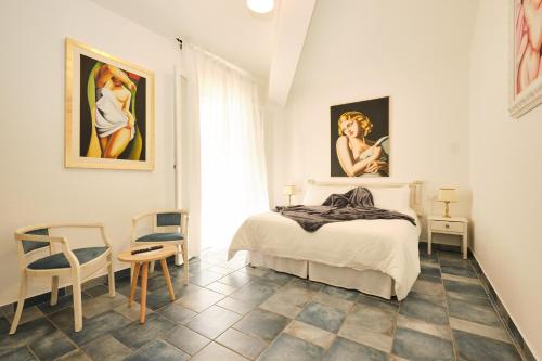 a bedroom with a bed and two paintings on the wall at La Villetta in Pula