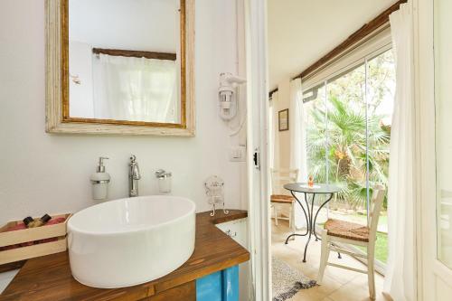 a bathroom with a large white sink and a table at La Villetta in Pula