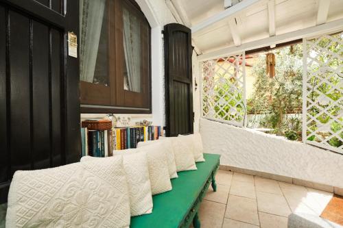 a row of white chairs in a room with a window at La Villetta in Pula