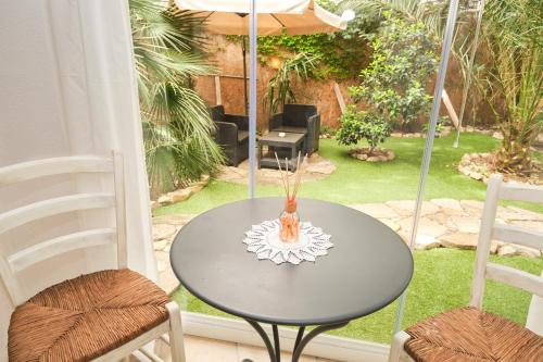 a table with two chairs and an umbrella on a patio at La Villetta in Pula