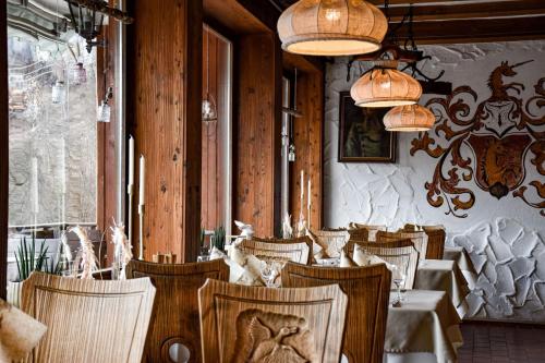 a dining room with tables and chairs and lights at Gasthaus Jägerhaus in Fridingen an der Donau