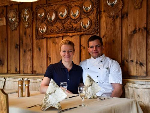 a man and woman sitting at a table in a restaurant at Gasthaus Jägerhaus in Fridingen an der Donau