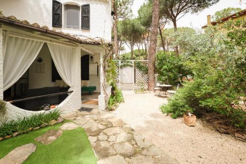 a house with a patio and a yard with grass at La Villetta in Pula