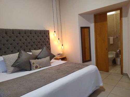 Ein Bett oder Betten in einem Zimmer der Unterkunft ArcoSodi Hotel Boutique