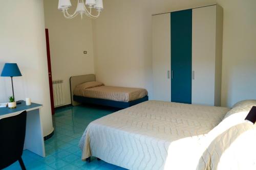 a bedroom with two beds and a desk and a bed at Atomos in Alvignano
