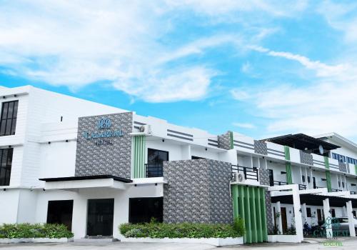 a white building with a sign on it at Casaroyal Hotel powered by Cocotel in Concepcion