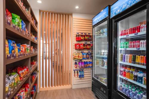 a grocery store aisle with a refrigerator and drinks at Holiday Inn Express & Suites Sanford - Lake Mary by IHG in Sanford