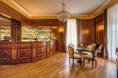 
a kitchen with a dining room table and chairs at Grand Hotel Wagner in Palermo
