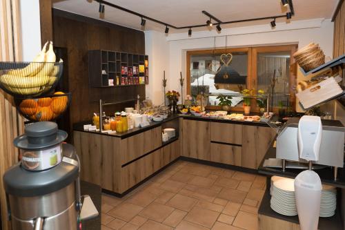 a kitchen with a counter with food on it at Hotel Tristkogel in Saalbach Hinterglemm
