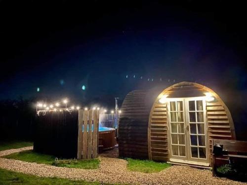 a small cabin at night with lights on it at Skipbridge farm glamping in York