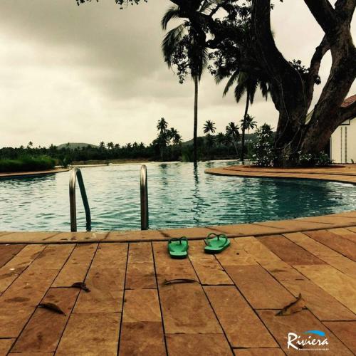 a pair of green shoes sitting next to a pool at Riviera Sapphire in Siolim