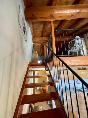 a staircase in a house with wooden ceilings at Appartamento la Torre Vinadio in Vinadio