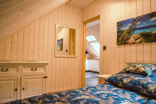 a bedroom with a bed and a window at Apartament w lesie, na odludziu z widokami in Jaszczurowa