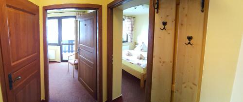 a room with a bedroom with a bed and a door at Pension Gemshorn in Hainzenberg