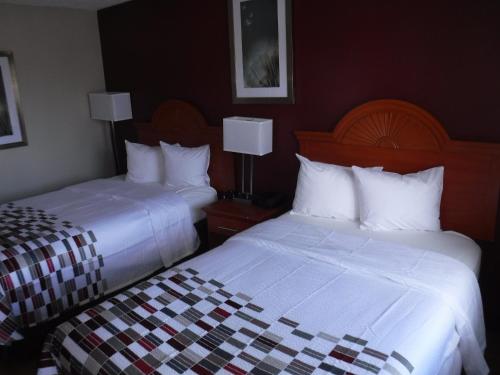 a hotel room with two beds and two lamps at Red Roof Inn Morton Grove in Morton Grove