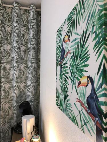 a candle and a picture of a bird on a wall at Equateur-centre Jaude in Clermont-Ferrand