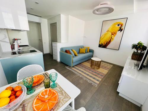 a living room with a table with fruits on it at AMBER APARTMENTS - SUNNY STUDIO in Morro del Jable