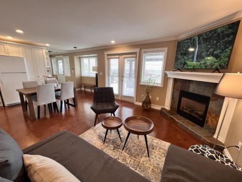 a living room with a couch and a fireplace at Lovely J Home -Stunning river view cozy two bedroom private suite in New Westminster