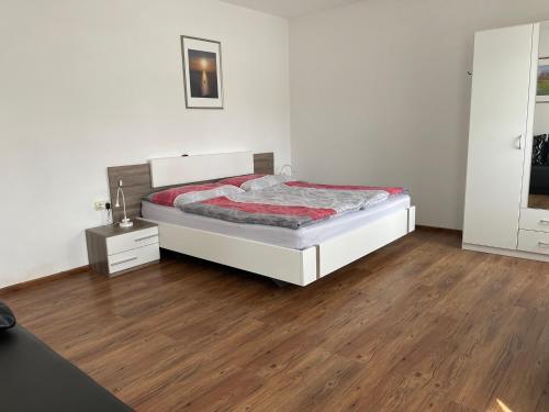 a bedroom with a bed and a wooden floor at Ferienhaus Russ in Bad Radkersburg